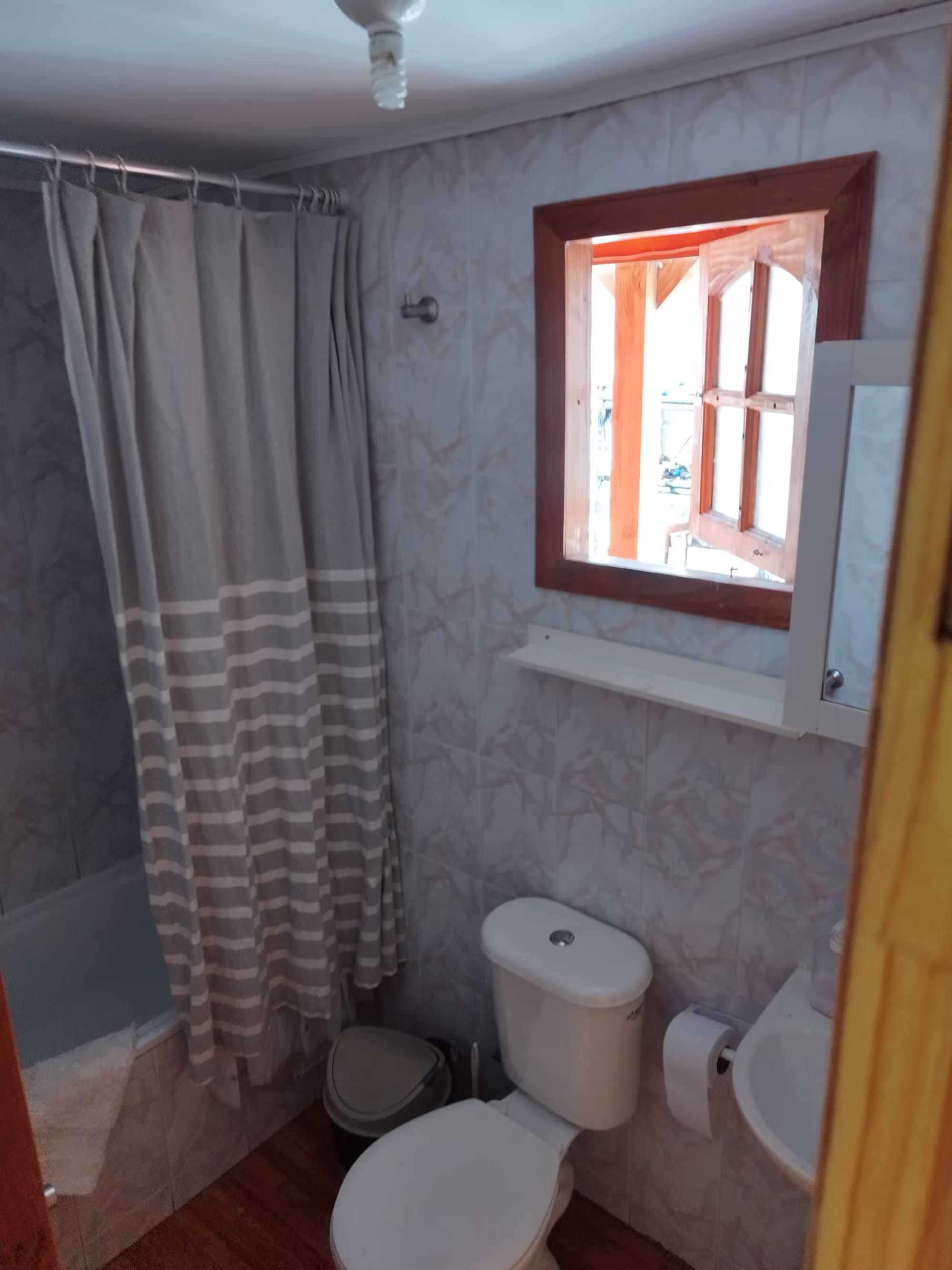 El baño con ducha y ventana